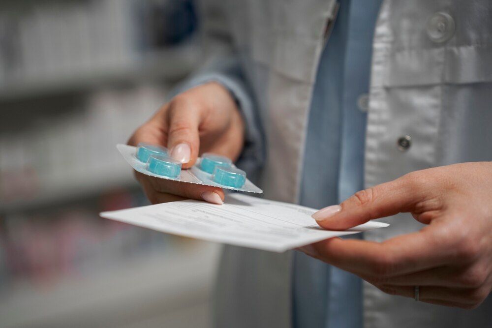 Female pharmacist with pills and medicine